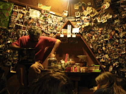 imgae of person making sauerkraut in front of a wall covered in polaroid pictures